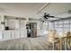 Bright dining area features white cabinets and walls, a dining table, and tiled floors at 4525 Landing Rd., Little River, SC 29566