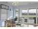 Bright dining room with a chandelier, dining table set for six, and access to a covered porch at 4525 Landing Rd., Little River, SC 29566