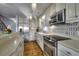 A spacious kitchen with stainless steel appliances, ample counter space, and wood flooring at 4525 Landing Rd., Little River, SC 29566