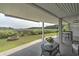 Enjoy the lovely backyard view from the covered patio with tile flooring and outdoor dining space at 4525 Landing Rd., Little River, SC 29566