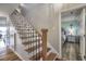 Staircase with wood steps and decorative iron railing leading to the second floor and bedroom at 4525 Landing Rd., Little River, SC 29566