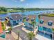 Aerial view of charming homes with a waterway view, boat docks, lush landscape and ample parking at 4534 Landing Rd., Little River, SC 29566
