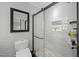 Bright bathroom featuring a modern shower with glass door, sleek black accents and pebbled shower floor at 4534 Landing Rd., Little River, SC 29566