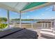 Covered deck featuring lounge chairs and a hot tub with views of the serene Intracoastal Waterway at 4534 Landing Rd., Little River, SC 29566