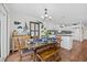 Dining area with wooden table, set for meal, decorative fish art, and white kitchen cabinets at 4534 Landing Rd., Little River, SC 29566