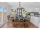Dining area with rustic table, set for a meal with coastal decorations and white kitchen cabinets at 4534 Landing Rd., Little River, SC 29566