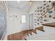 Bright foyer with staircase, hardwood floors, and art-filled walls create a welcoming entrance at 4534 Landing Rd., Little River, SC 29566