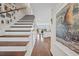 Grand two story staircase leading into an open floor plan with hardwood flooring at 4534 Landing Rd., Little River, SC 29566