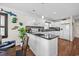 Bright kitchen boasts white cabinetry, granite countertops, mosaic backsplash, and hardwood flooring at 4534 Landing Rd., Little River, SC 29566