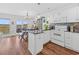 Open-concept kitchen with granite countertops, white appliances, and breakfast bar leading to dining area at 4534 Landing Rd., Little River, SC 29566