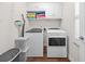 Functional laundry room with modern washer and dryer units, storage cabinets, and ample counter space at 4534 Landing Rd., Little River, SC 29566