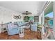 Spacious living room featuring stylish blue sofas, wood floors, large windows, and coastal decorations at 4534 Landing Rd., Little River, SC 29566