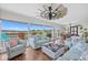 Open-concept living room with views of marina, stylish sofas, wood floors, and coastal decor at 4534 Landing Rd., Little River, SC 29566