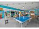 Spacious recreation room featuring a ping pong table, bar, and multiple colorful hammocks at 4534 Landing Rd., Little River, SC 29566