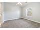 Bright and airy bedroom with neutral carpet, ceiling fan, and a window with a view at 4721 Hibiscus Dr. # 3-302, Little River, SC 29566