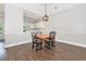 Dining area with hardwood floors next to an open kitchen and a balcony at 4721 Hibiscus Dr. # 3-302, Little River, SC 29566