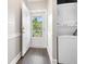 Hallway with a stacked washer and dryer unit and view of the outdoors through the storm door at 4721 Hibiscus Dr. # 3-302, Little River, SC 29566