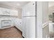 Bright kitchen with white cabinets and stainless steel appliances offers a clean and modern aesthetic at 4721 Hibiscus Dr. # 3-302, Little River, SC 29566