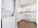 Kitchen features stacked washer/dryer and white cabinetry, adding convenience and style to the space at 4721 Hibiscus Dr. # 3-302, Little River, SC 29566