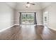 Bright living area with hardwood floors and a sliding glass door to the balcony at 4721 Hibiscus Dr. # 3-302, Little River, SC 29566