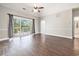 Spacious living room with hardwood floors and sliding glass doors to the balcony at 4721 Hibiscus Dr. # 3-302, Little River, SC 29566