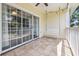 Covered porch with tile flooring, sliding glass doors, ceiling fan and a white swing at 4721 Hibiscus Dr. # 3-302, Little River, SC 29566