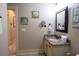 A well-lit bathroom featuring granite countertops, a framed mirror, and nautical decor at 4901 N Market St., North Myrtle Beach, SC 29582