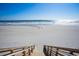 Picturesque beach view from wooden stairs leading down to the sand and ocean, perfect for beach access at 4901 N Market St., North Myrtle Beach, SC 29582