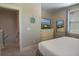 Neutral bedroom showcasing a large dresser with a TV, next to an open door at 4901 N Market St., North Myrtle Beach, SC 29582