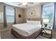 Comfortable bedroom with a metal frame bed, two windows, and neutral decor at 4901 N Market St., North Myrtle Beach, SC 29582