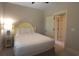 Cozy bedroom with neutral tones, bedside table, and an adjoining doorway at 4901 N Market St., North Myrtle Beach, SC 29582