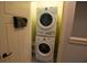 A stacked washer and dryer unit in a small, enclosed laundry area at 4901 N Market St., North Myrtle Beach, SC 29582