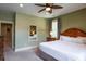Well-lit main bedroom with a ceiling fan, a framed mirror and carpeted floors at 4901 N Market St., North Myrtle Beach, SC 29582