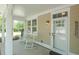 Relaxing front porch featuring rocking chairs, a stylish front door, and pleasant natural light at 4901 N Market St., North Myrtle Beach, SC 29582