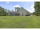 Exterior view of home with large yard and screened porch at 499 Trestle Way, Conway, SC 29526