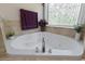 Elegant bathroom featuring a corner jacuzzi tub, designer tile, and natural light at 499 Trestle Way, Conway, SC 29526