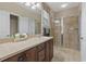 Neutral bathroom features a large vanity and walk-in shower with neutral tile surround at 499 Trestle Way, Conway, SC 29526