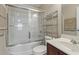Well-lit bathroom featuring a shower-tub combo, dark wood vanity, and ample lighting at 499 Trestle Way, Conway, SC 29526