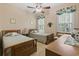 Cozy bedroom featuring twin beds, ceiling fan, and bright natural light at 499 Trestle Way, Conway, SC 29526