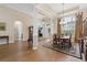 Formal dining room with elegant columns, a grand chandelier, and hardwood floors at 499 Trestle Way, Conway, SC 29526