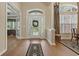 Elegant foyer featuring a glass-paneled front door, hardwood floors, and ample natural light at 499 Trestle Way, Conway, SC 29526