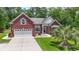 Beautiful single-story red brick home with a well-maintained lawn, a two-car garage, and mature landscaping at 499 Trestle Way, Conway, SC 29526