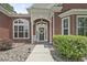Inviting front entrance with a decorative wreath, white rocking chair, and manicured bushes at 499 Trestle Way, Conway, SC 29526