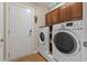 Functional laundry room with washer, dryer, and storage cabinets at 499 Trestle Way, Conway, SC 29526