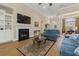 Spacious living room featuring hardwood floors, a fireplace, built-in shelving, and abundant natural light at 499 Trestle Way, Conway, SC 29526