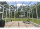 Screened porch with lounge chair overlooks spacious backyard at 499 Trestle Way, Conway, SC 29526