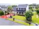 Aerial view of home featuring a well-kept lawn, mature trees and landscaping on a corner lot at 5096 Capulet Circle, Myrtle Beach, SC 29588