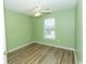 Cozy bedroom with wood-look floors, light green walls, and a window allowing natural light at 5096 Capulet Circle, Myrtle Beach, SC 29588