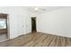 Bedroom with wood-look floors, neutral walls, and bright natural light streaming in through a glass patio door at 5096 Capulet Circle, Myrtle Beach, SC 29588