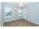 Cozy bedroom with wood-look floors, two windows, and a ceiling fan at 5096 Capulet Circle, Myrtle Beach, SC 29588